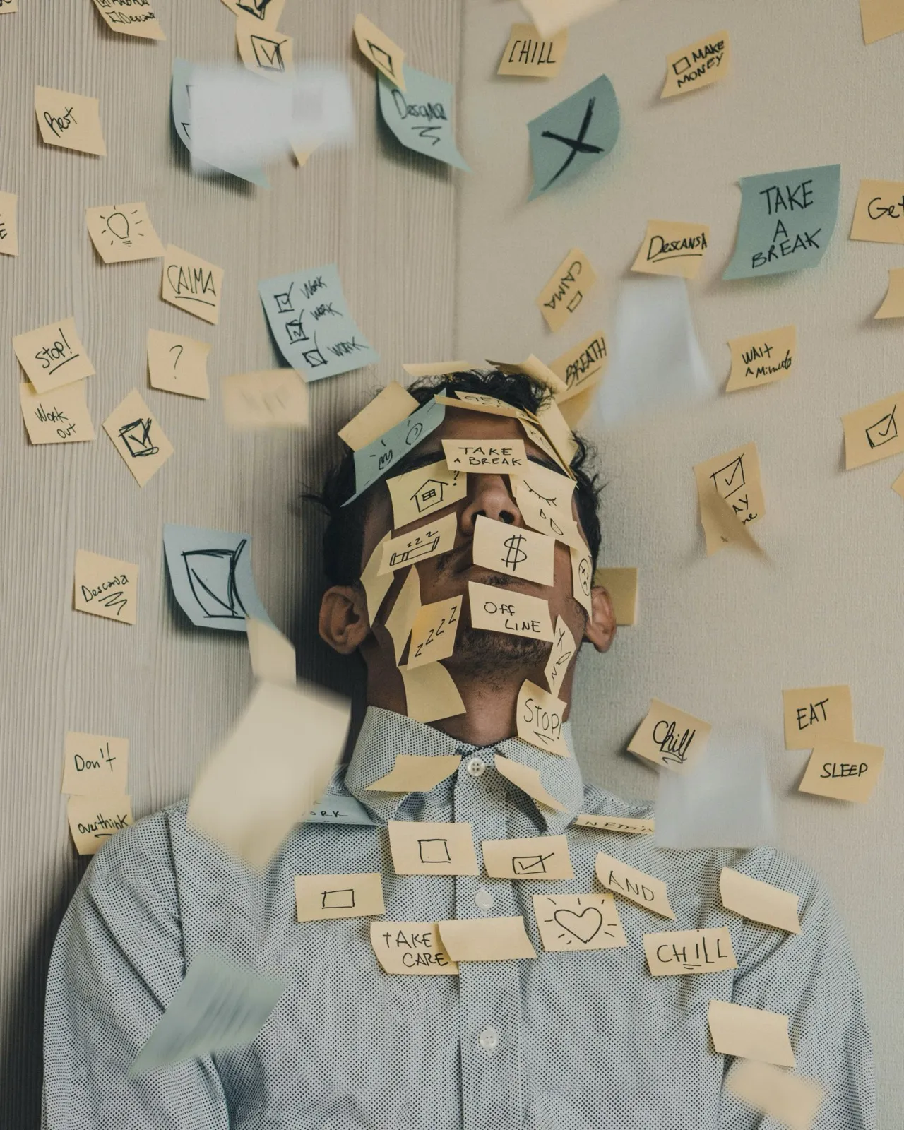 Homme recouvert de post-it, débordé par ses tâches